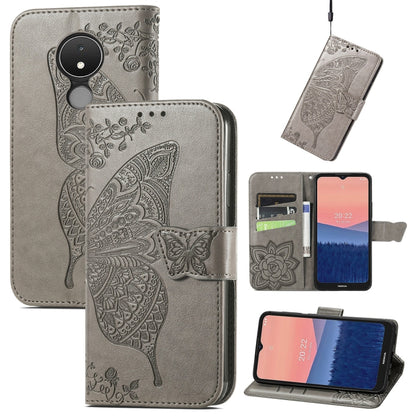 Gray flip phone case with embossed butterfly and floral design, leather wallet style