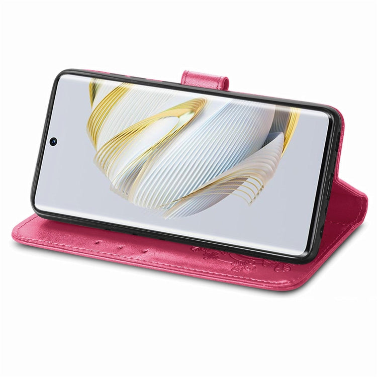 Pink leather folio phone case with embossed floral detail and clasp stand strap