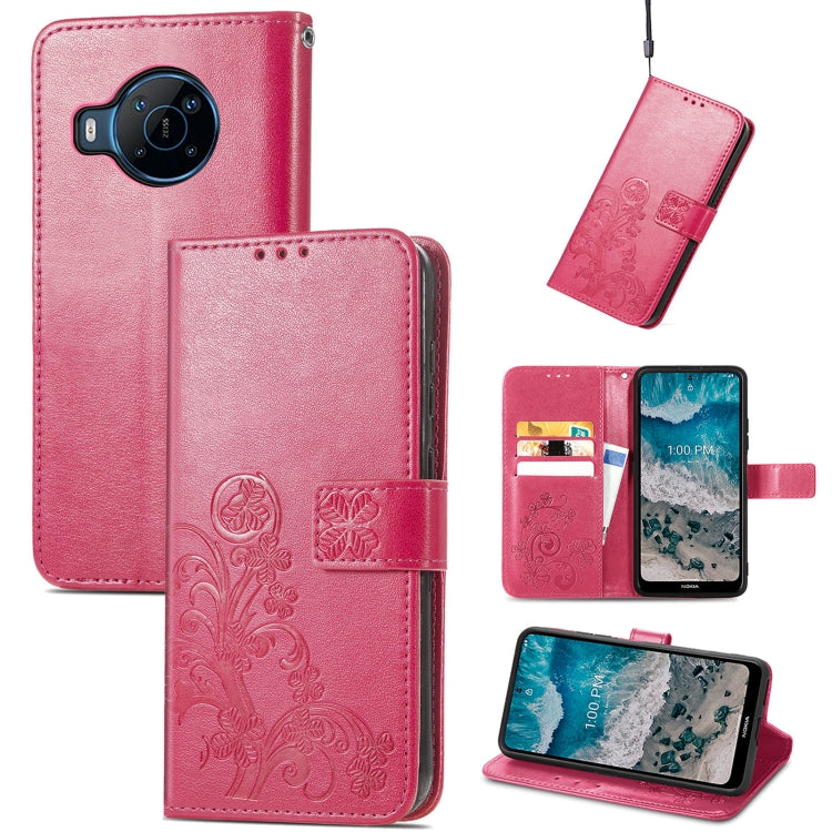 Raspberry pink leather phone case with embossed four-leaf clasp and card holder slots