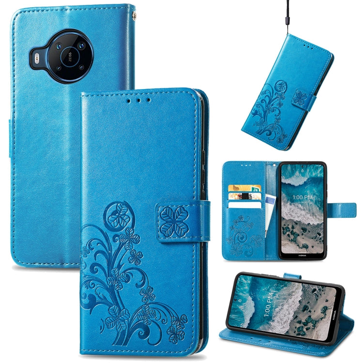 Blue leather flip phone case with embossed floral four-leaf clasp and buckle closure