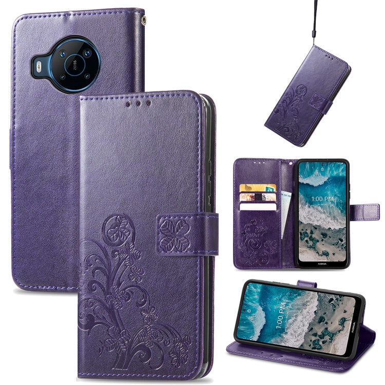 Purple leather flip phone case with embossed floral four-leaf clasp and buckle closure