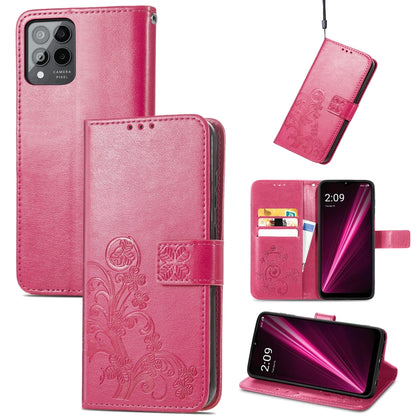 Pink leather phone case with embossed floral clover, clasp buckle, and card slots