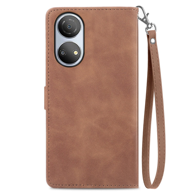 Brown leather phone case with stitched edges and embossed floral pattern back