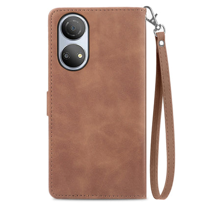 Brown leather phone case with stitched edges and embossed floral pattern back