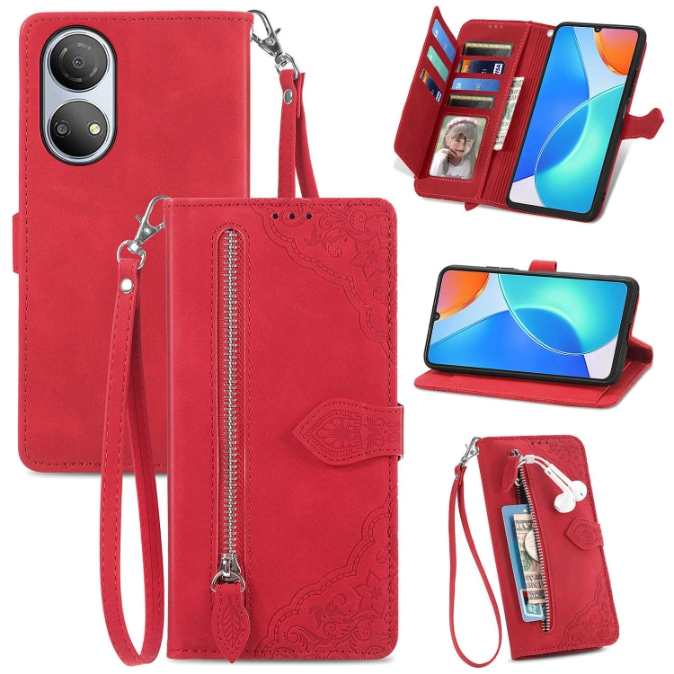 Red leather phone wallet case with embossed floral pattern, zipper, and wrist strap