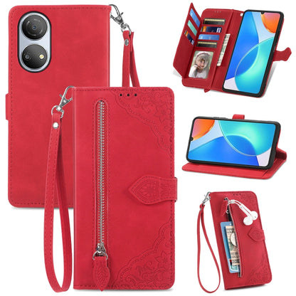 Red leather phone wallet case with embossed floral pattern, zipper, and wrist strap