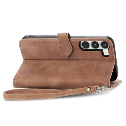 Brown leather phone case with camera cutout and wrist strap