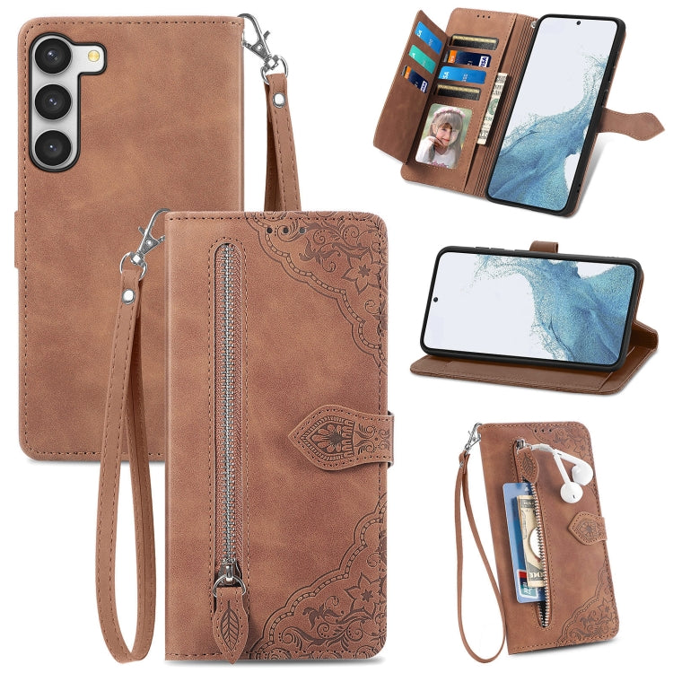 Brown embossed leather wallet phone case with zipper panel and wrist strap