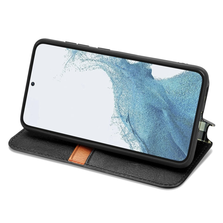 Black folio leather phone case with magnetic flap standing for viewing, cubic grid texture.