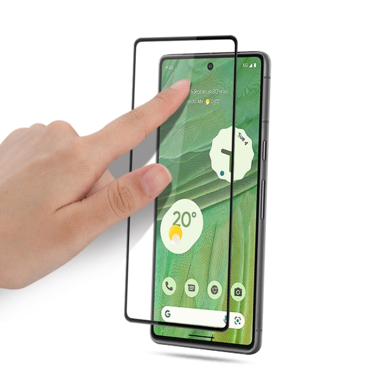 Tempered glass screen protector film being applied to smartphone display