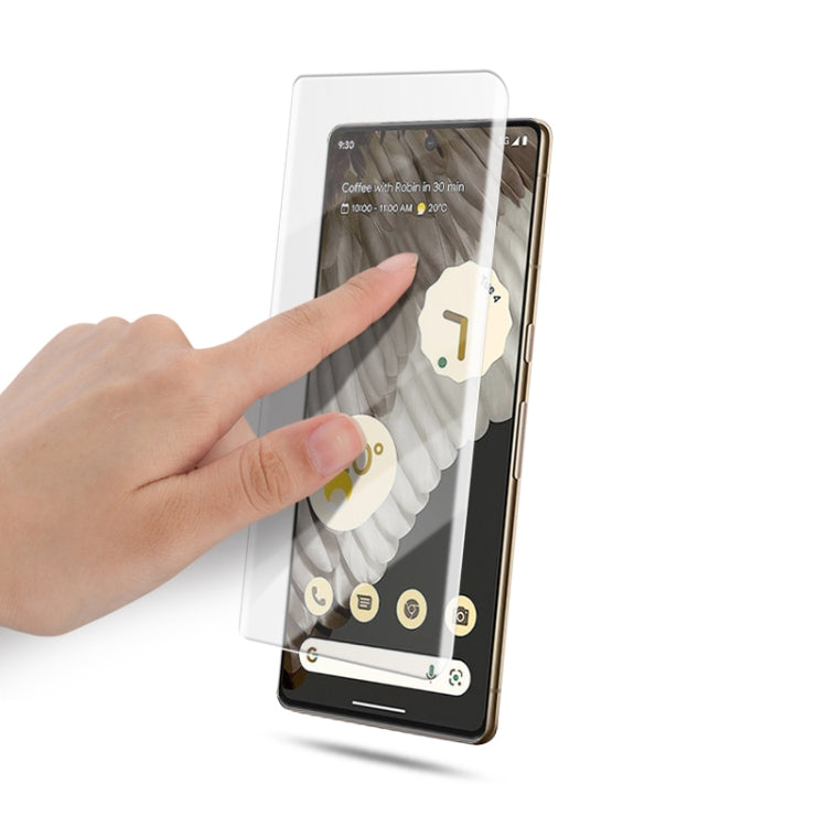 Full-screen tempered glass protector for Pixel 7 Pro being applied by hand