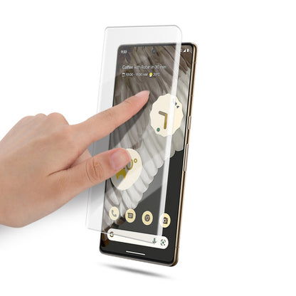 Full-screen tempered glass protector for Pixel 7 Pro being applied by hand