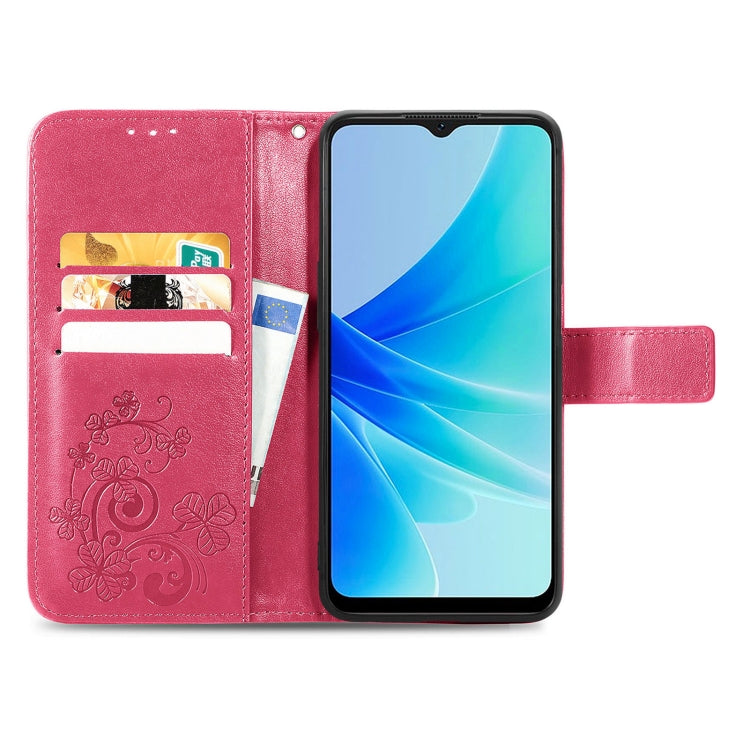 Rose pink folio phone case with embossed floral pattern, buckle strap, and card slots.