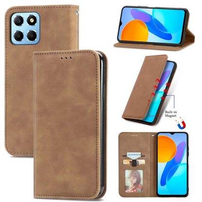 Brown magnetic flip leather phone case with camera cutout and speaker opening.