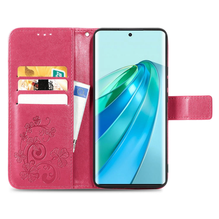 Pink leather phone case with embossed floral pattern, clasp buckle, and card slots