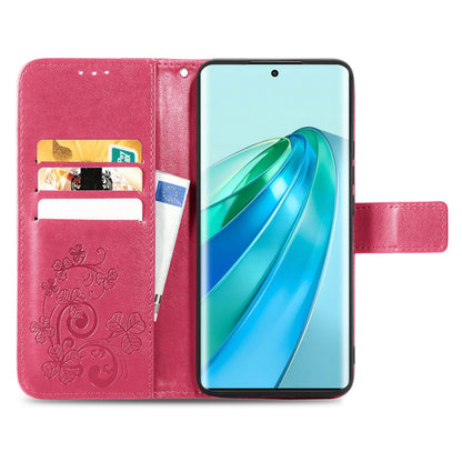 Pink leather phone case with embossed floral pattern, clasp buckle, and card slots