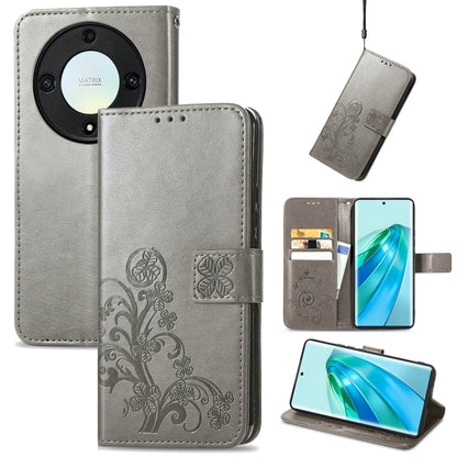 Gray leather phone case with four-leaf embossing, clasp closure, and card slots