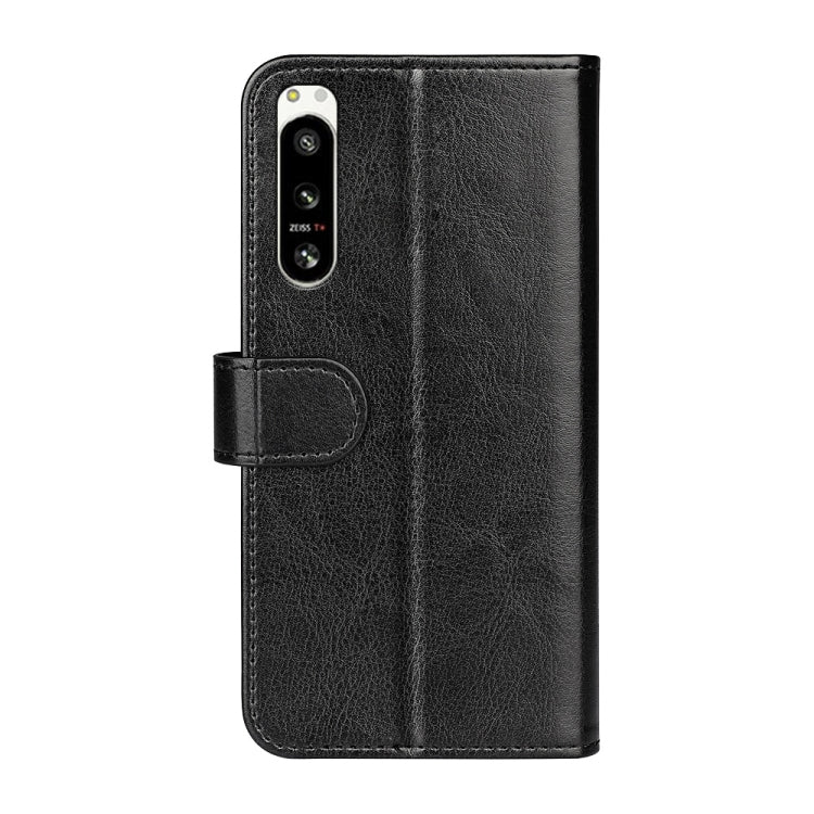 Black textured flip leather phone case with camera cutout and side strap