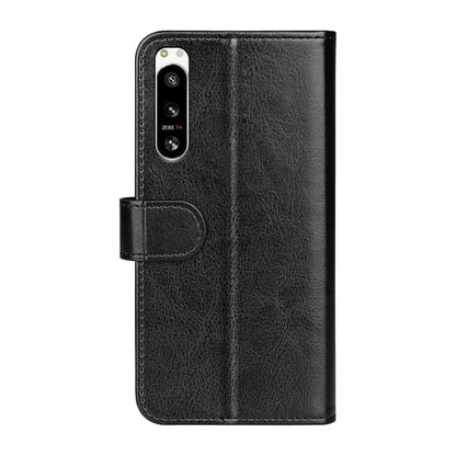 Black textured flip leather phone case with camera cutout and side strap