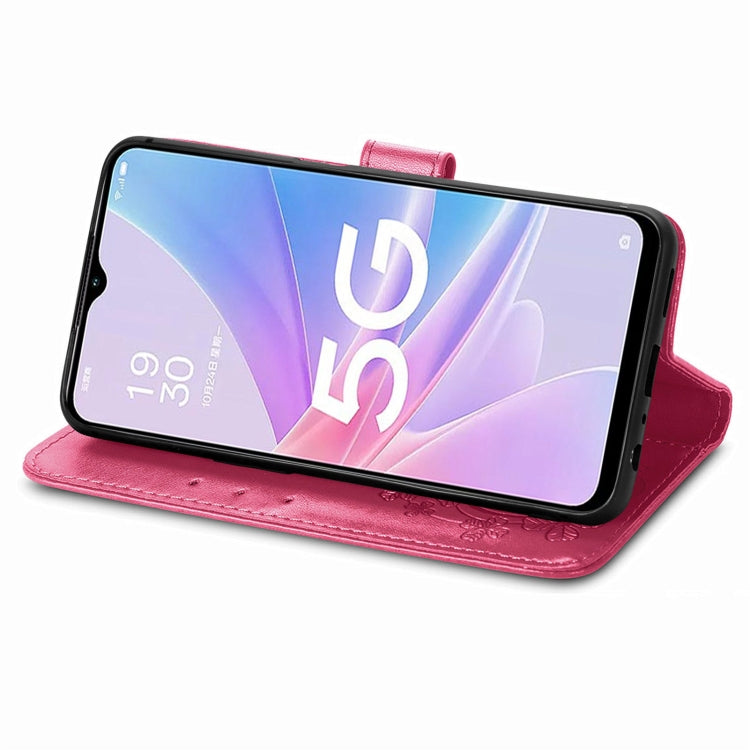 Magenta leather folio phone case with embossed floral design and clasp buckle, stand mode