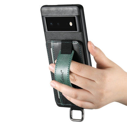 Green card wallet phone case with wrist strap; hand holding the front view.
