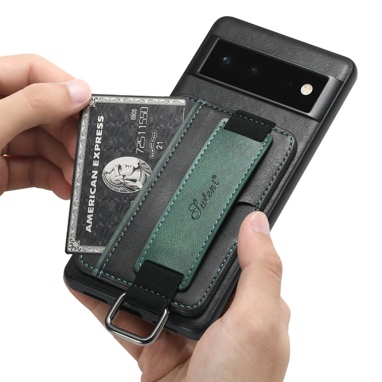Black phone wallet case with green card slot; hands inserting a card into holder.