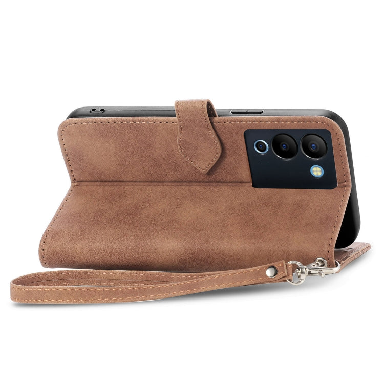 Brown embossed leather phone case with side zipper, wrist strap, and camera cutout
