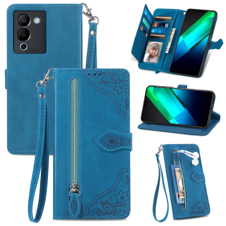 Blue leather phone wallet case with embossed flower pattern, zipper, wrist strap, card slots.