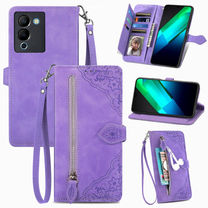 Purple leather phone wallet case with embossed flower pattern, zipper compartment and wrist strap.