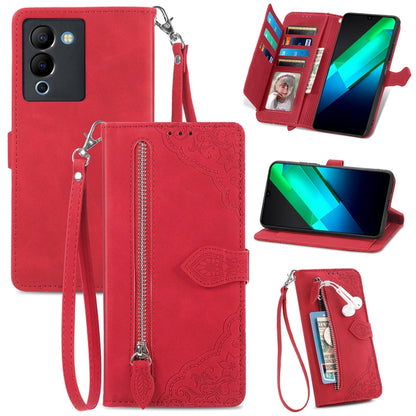 Red embossed floral leather-style phone case with front zipper, wrist strap, and card slots