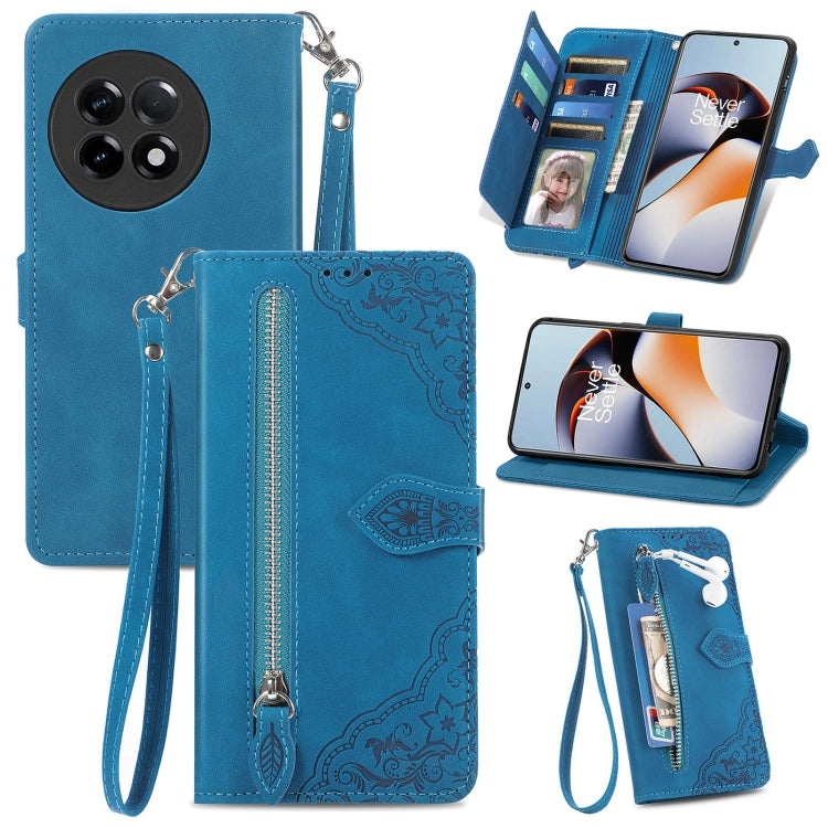 Blue leather phone wallet case with embossed floral design, zipper pull, wrist strap, card slots.