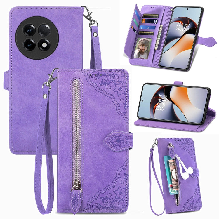 Purple leather phone wallet case with embossed floral design, zipper closure, wrist strap, slots.