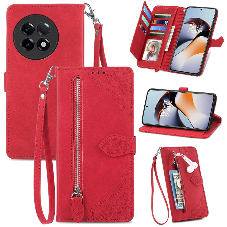 Red embossed floral leather-style phone case with front zipper and wrist strap