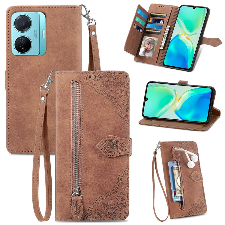 Brown embossed flower leather wallet phone case with card slots and zipper closure