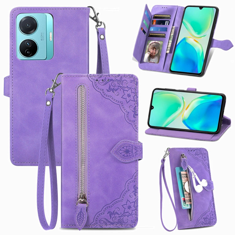 Purple embossed floral leather-style phone case with front zipper, strap, and card slots