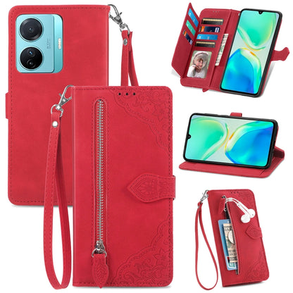 Red embossed floral leather-style phone case with front zipper pocket and wrist strap