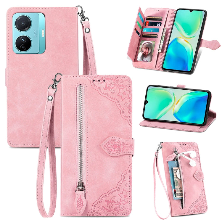 Light pink embossed flower leather phone case with zipper closure and wrist strap