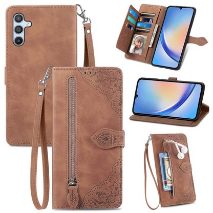 Brown leather phone wallet case with embossed flower pattern, zipper, wrist strap, card slots.