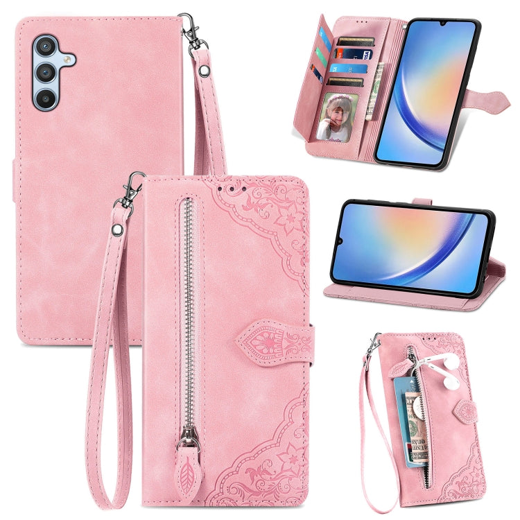 Pink embossed flower leather phone case with zipper pocket, card slots, and wrist strap