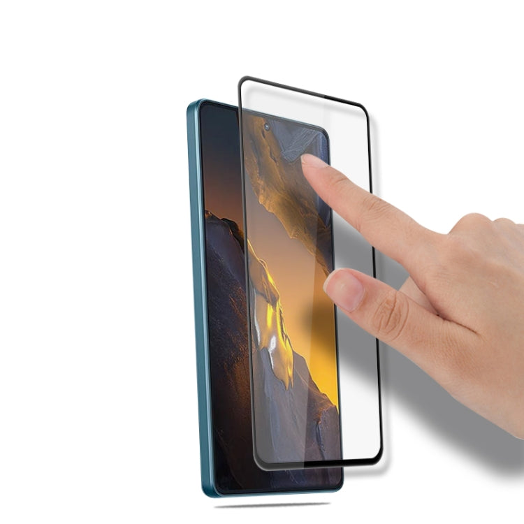 9H tempered glass screen protector film being applied to smartphone screen