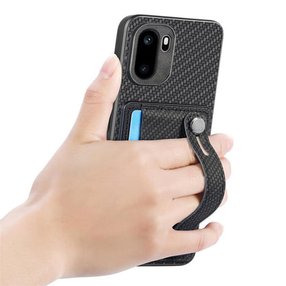 Black wallet phone case with wristband kickstand, shown held in a hand