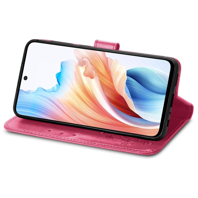 Rose red leather folio phone case with buckle strap, embossed floral detail, kickstand view