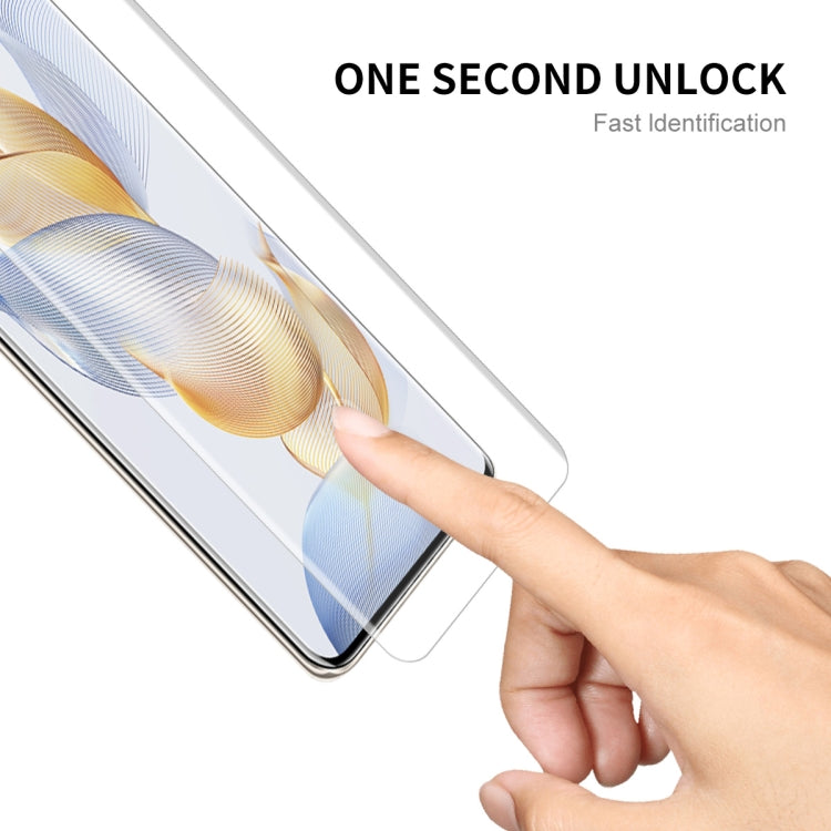 Hand applying curved screen protector film to smartphone display edge