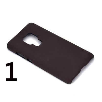 Dark brown/black phone case with camera cutout and small bottom port holes
