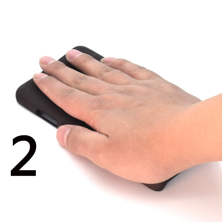 Black phone case held in hand, showing camera cutout and bottom edge openings