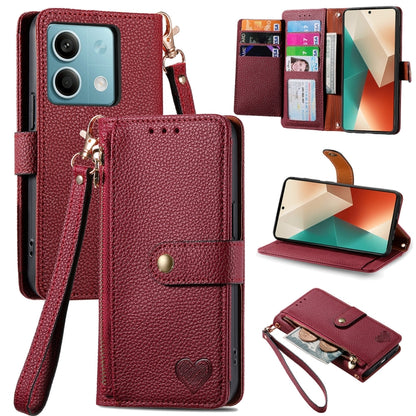 Dark red leather-style phone wallet case with zipper, lanyard strap, and heart emblem