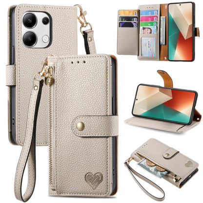 Cream leather phone case with wrist lanyard, card slots, heart strap detail, stand view
