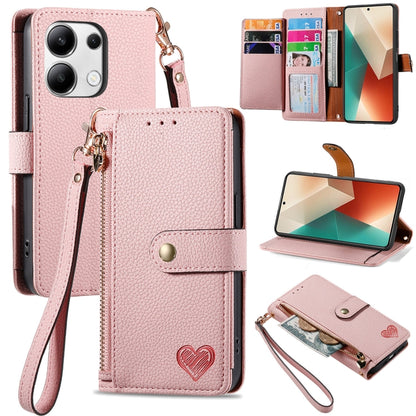Pink leather phone case with wrist lanyard, card slots, heart strap detail, stand view