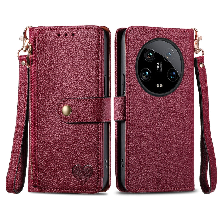 Burgundy leather-style phone case with zipper, lanyard strap, and heart emblem front flap