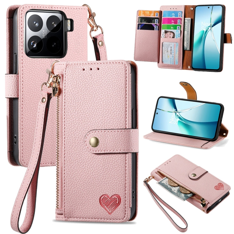 Pink leather phone case with wrist strap, card slots, and heart emblem